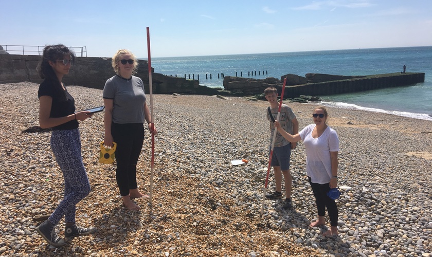 Students standing on the beach